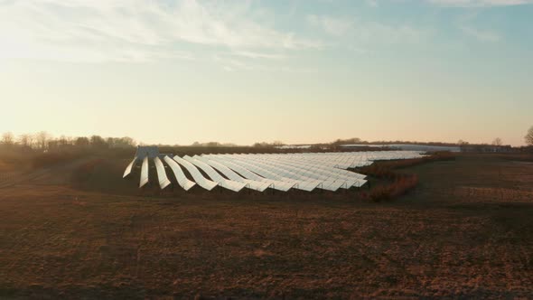 Drone Flight Towards Rows Of Solar Panels In Field