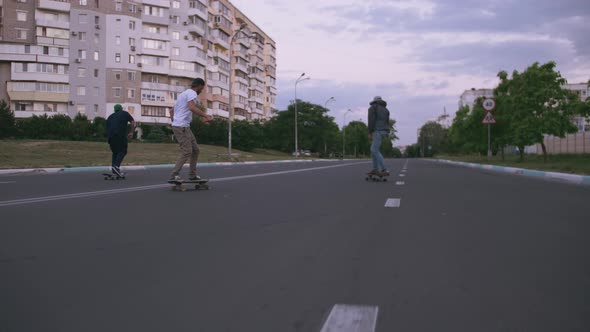 Group of Young People Skateboarding on the Road in the Early Morning Cinematic Shot Slow Motion