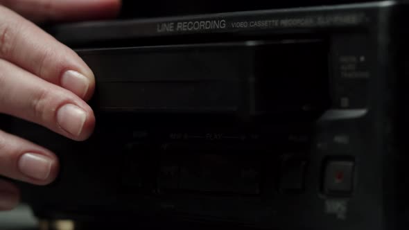 Putting Video Cassette Into Recorder