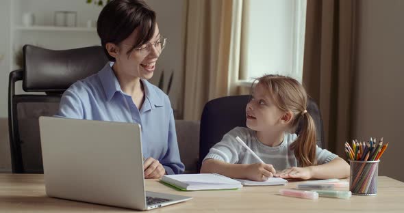 Portrait of Two Female Persons, Young Smiling Woman Uses Computer for Presentation in Lesson with