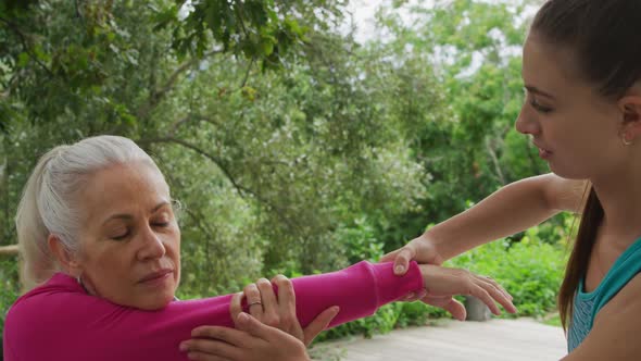 Senior woman exercising in a garden