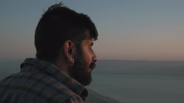 Middle eastern man looking at sunset