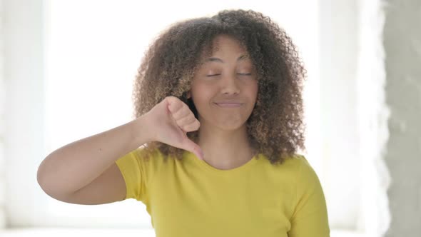 African Woman showing Thumbs Down Gesture