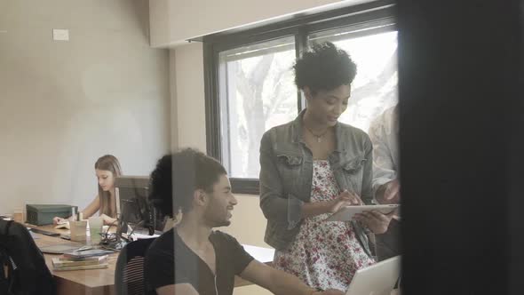 Colleagues collaborating in office