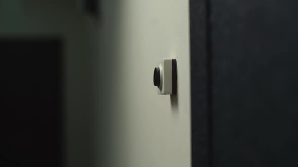 Closeup Hand of Unrecognizable Man Pushing Doorbell Button in Entryway of Apartment Building