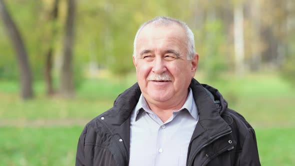 Senior Man with a Mustache in the Park