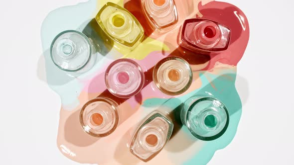 Multicolored Nail Polish Samples Spilled on White Background Isolated