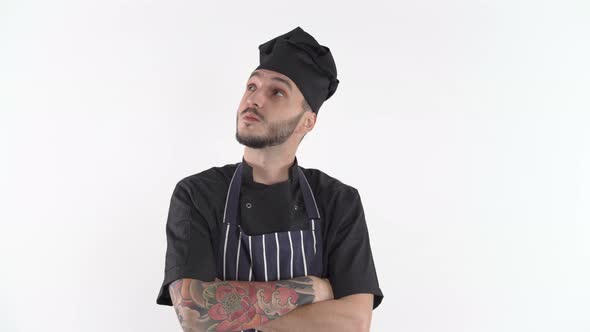 Confused Chef in Uniform Thinking What To Cook, Scratching His Beard