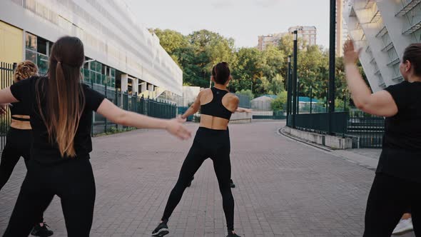 Back View of Group of Women Performing Dances in City Street Fitness