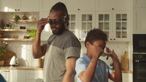 Positive School Age Black Boy and Dad in Sunglasses with Arms Crossed Smiling