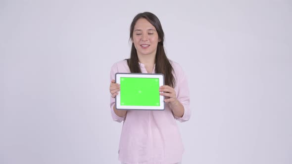 Young Happy Multi-ethnic Businesswoman Showing Digital Tablet