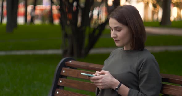 Happy Girl Using a Smart Phone Voice Recognition Audio Message Function on Line Walking on a Street