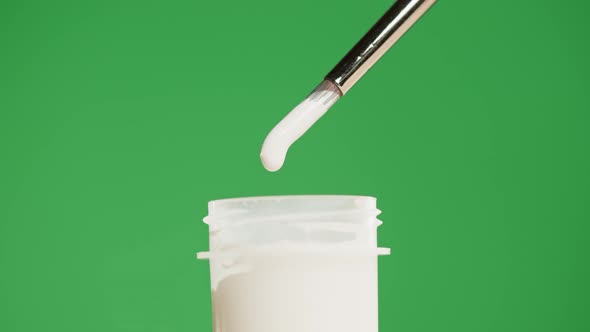 White Paint Isolated on Green Background