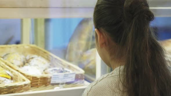 Close Up of a Cute Little Girl Smiling To the Camera at the Bakery