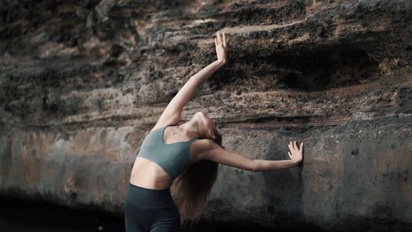 Woman Doing Stretching Exercises and Dances on Beach Near Cliff Slow Motion