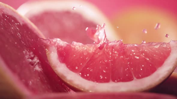 Slow Motion Shot of Grapefruit Juice Splashing Through Grapefruit Slices