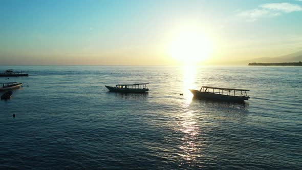 Aerial drone view landscape of idyllic sea view beach trip by shallow sea with white sandy backgroun