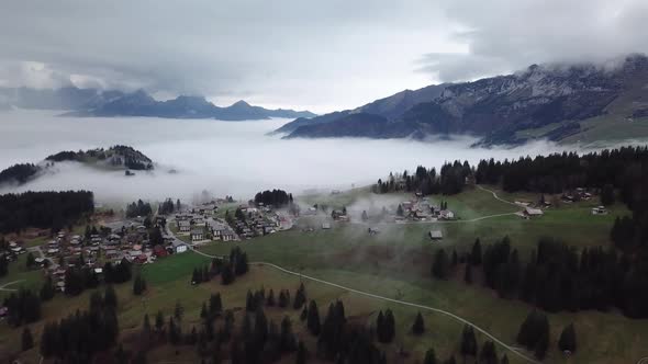 Aerial View Over Mist Covered Town In Arvenbuel In Switzerland