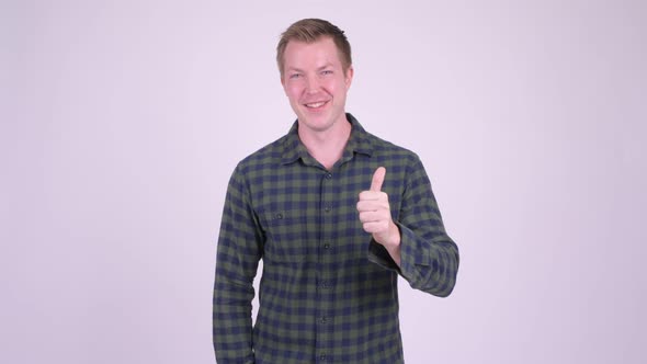 Young Happy Man Doing Various Gestures While Smiling