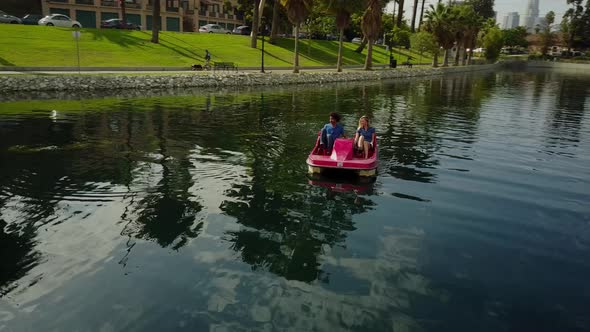 Cute Couple Enjoying A Boat Ride In The Park