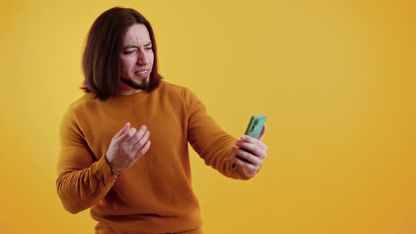 Excited Bearded Caucasian Man Watching Football Match Transmission on His Modern Smartphone