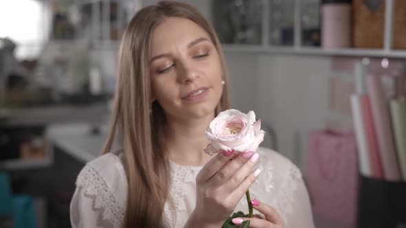 The Woman Rejoices at the Beautiful Flower in Her Hands