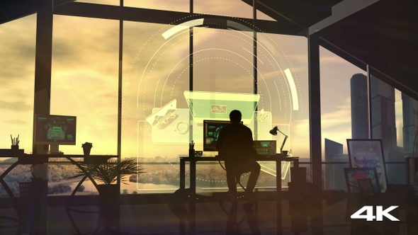 In the evening, a designer works at the table in the office 4K alt