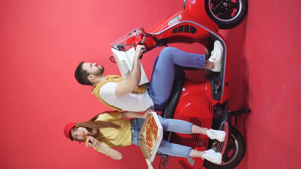 Young Woman Rides with a Courier Boyfriend Delivering Food Orders on a Motorcycle, She Eats Pizza
