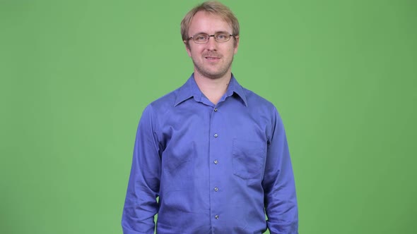 Happy Handsome Blonde Businessman Smiling with Arms Crossed