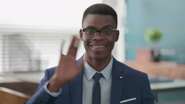 Young African Businessman Waving Hand for Hello Welcoming