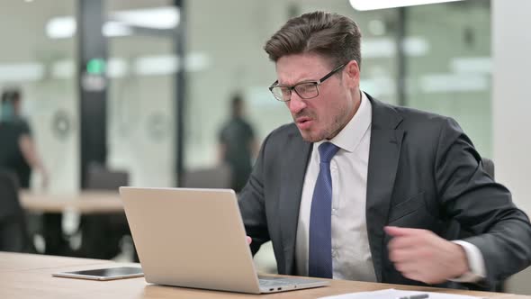 Tired Middle Aged Businessman with Laptop Having Back Pain in Office 