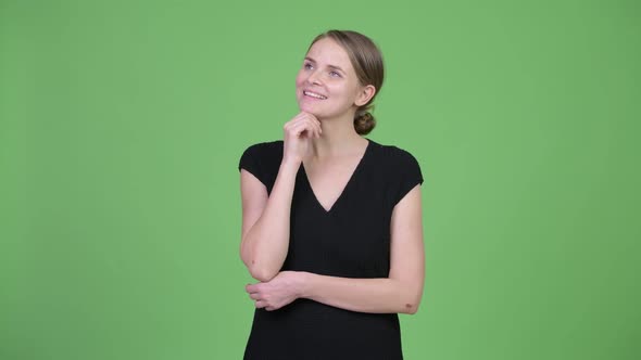 Young Happy Beautiful Businesswoman Smiling and Thinking