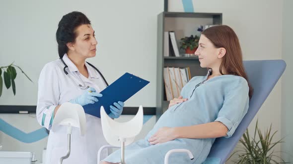 Female Doctor Examine Pregnant Young Mother To Check Up Her Healthcare. Teenage Pregnancy