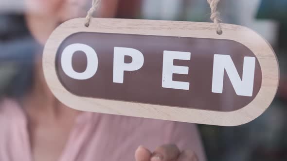Small business opening up. Turning the sign from close to open. 4k 60fps