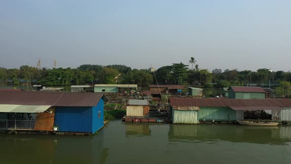 Floating fish farming community in Bien Hoa on the Dong Nai river, Vietnam on a sunny day. Drone tra