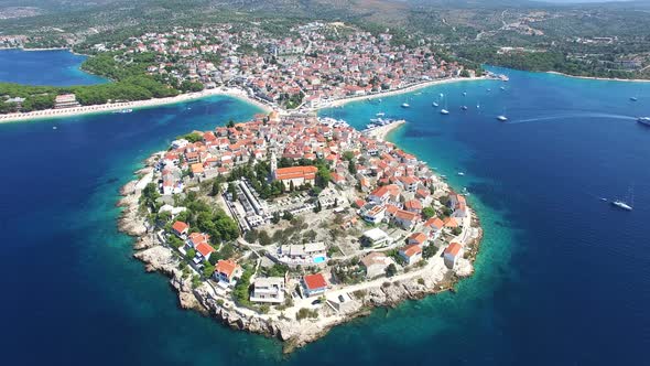 Flying above traditional dalmatian houses on Primosten peninsula, Croatia