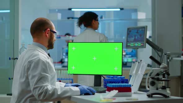 Man Researcher Looking at Chroma Key Display of Computer