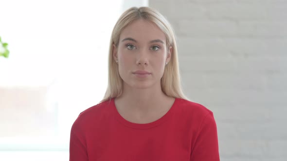 Young Blonde Woman Looking at the Camera