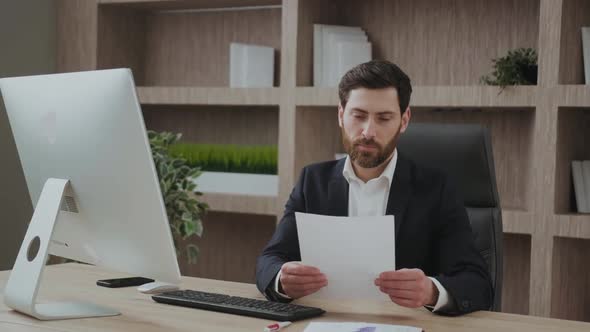 Handsome Middleaged Businessman is Happy Wiht Results Looks Happy and Delighted at His Workplace