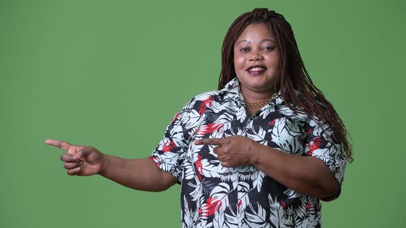 Overweight Beautiful African Woman Against Green Background