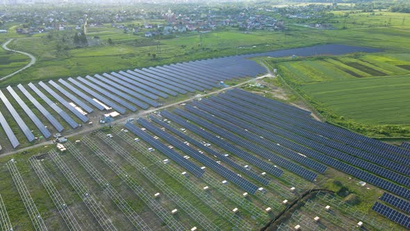 Aerial View of Big Electric Power Plant Under Construction with Many Rows of Solar Panels on Metal