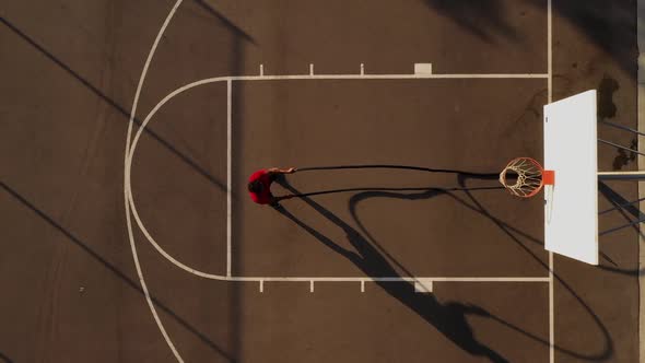 Aerial shot of a man working out with battle ropes