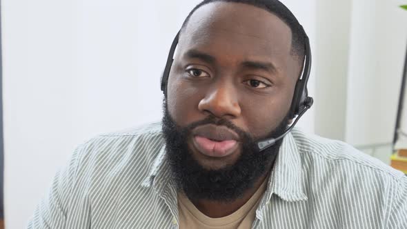 Closeup African American Man in Headphones Call Center Operator Hotline Expert Talking Remotely