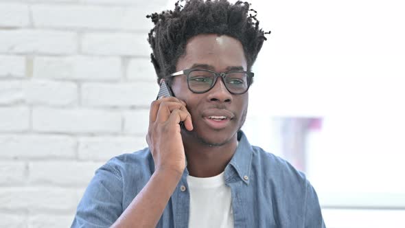 Young African Man Talking on Smartphone