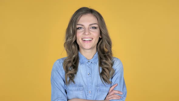 Smiling Young Girl Isolated on Yellow Background