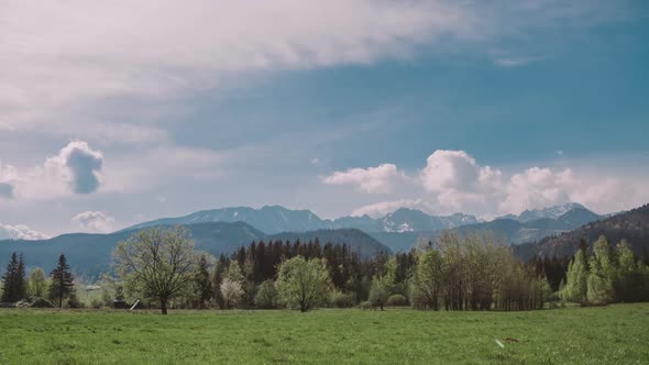 Mountain Peaks and Morning Sky with Moving Clouds. Summer Landscape