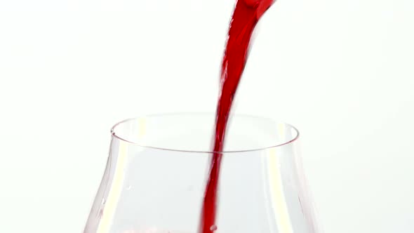 Red Wine Pouring Into a Glass, White, Closeup