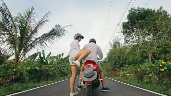 Love Couple on Red Motorbike in White Clothes to Go on Forest Road Trail Trip