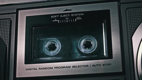 Audio Cassette Playing and Rotates in Retro Tape Recorder