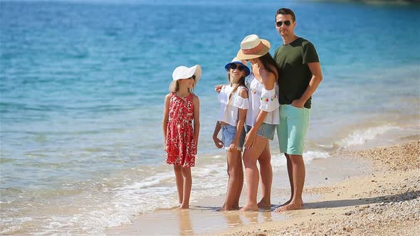 Happy Family on a Beach During Summer Vacation